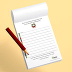 Notepad with Christmas design and a red pen on a beige background