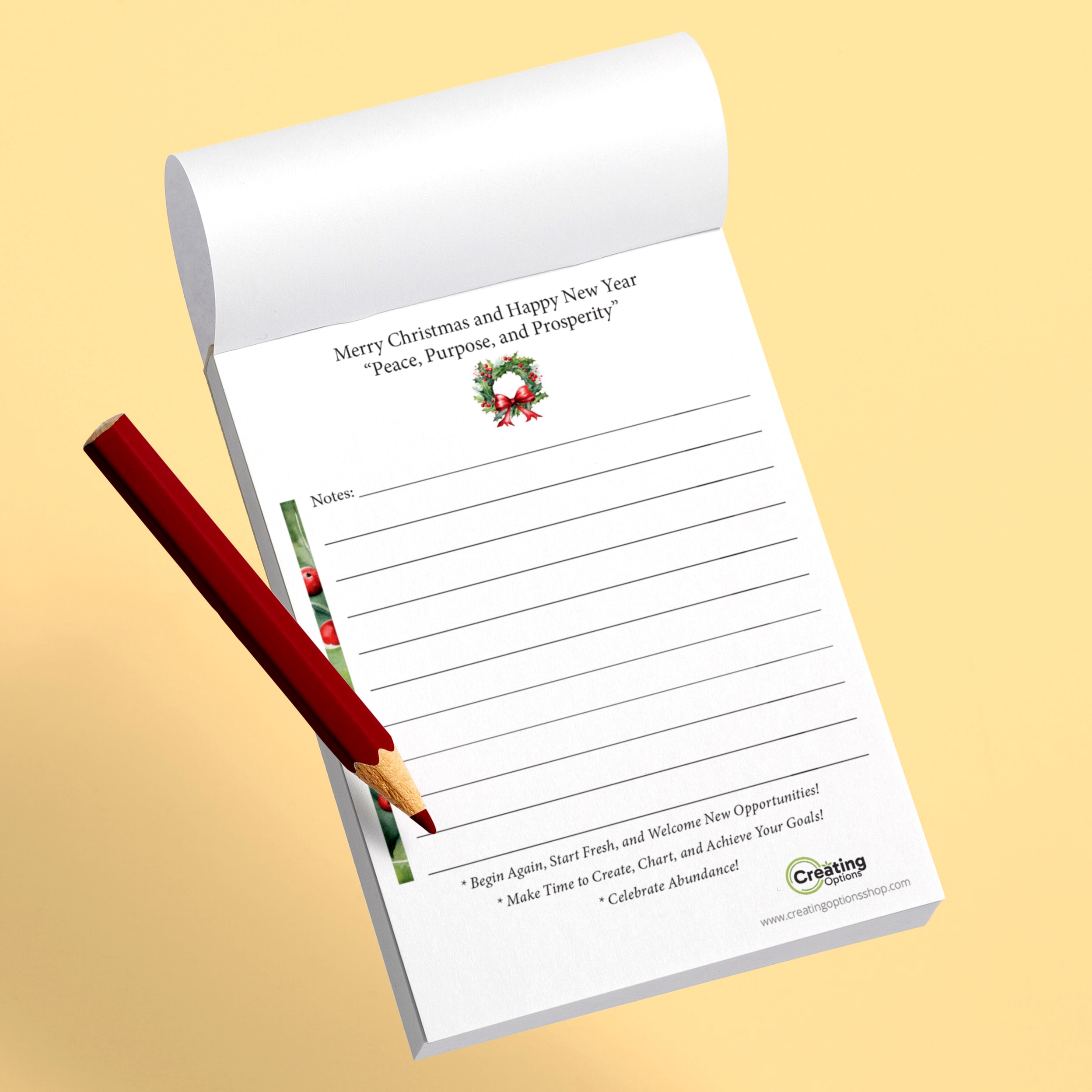 Notepad with Christmas design and a red pen on a beige background
